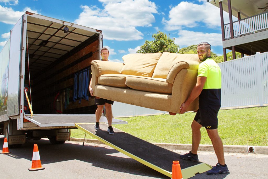 Professional movers moving a couch